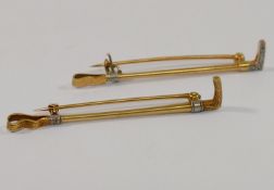 A yellow metal diamond set stock pin in the form of a riding crop,