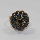 A yellow metal sapphire circular bombè-shaped cluster ring,