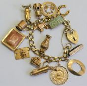 A 9 carat gold filed curb link charm bracelet with fifteen 9 carat gold and yellow metal charms,