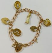 A yellow metal curb link charm bracelet, with 9 carat gold heart-shaped padlock clasp, London 1980,