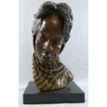 A head study of an African lady wearing a scarf, bronze with gilt detail, on rectangular plinth,