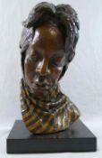 A head study of an African lady wearing a scarf, bronze with gilt detail, on rectangular plinth,