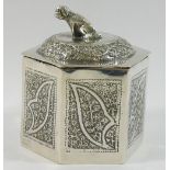 A small Middle Eastern silver coloured metal lidded box, with dog finial, unmarked, 7cm high, 2.