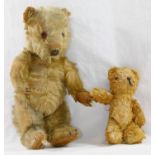 An early 20th century blonde mohair plush jointed teddy bear with glass eyes,