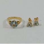 A yellow metal single stone aquamarine ring, housed in four claw setting, the shank stamped '14K',