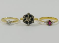 A yellow metal garnet and diamond ring, the shank stamped '750', finger size O 1/2,