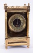 A Victorian brass cased mantle clock, with gong strike of architectural form, the dial