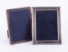 Two silver photo frames, the largest 22cm x 17cm.