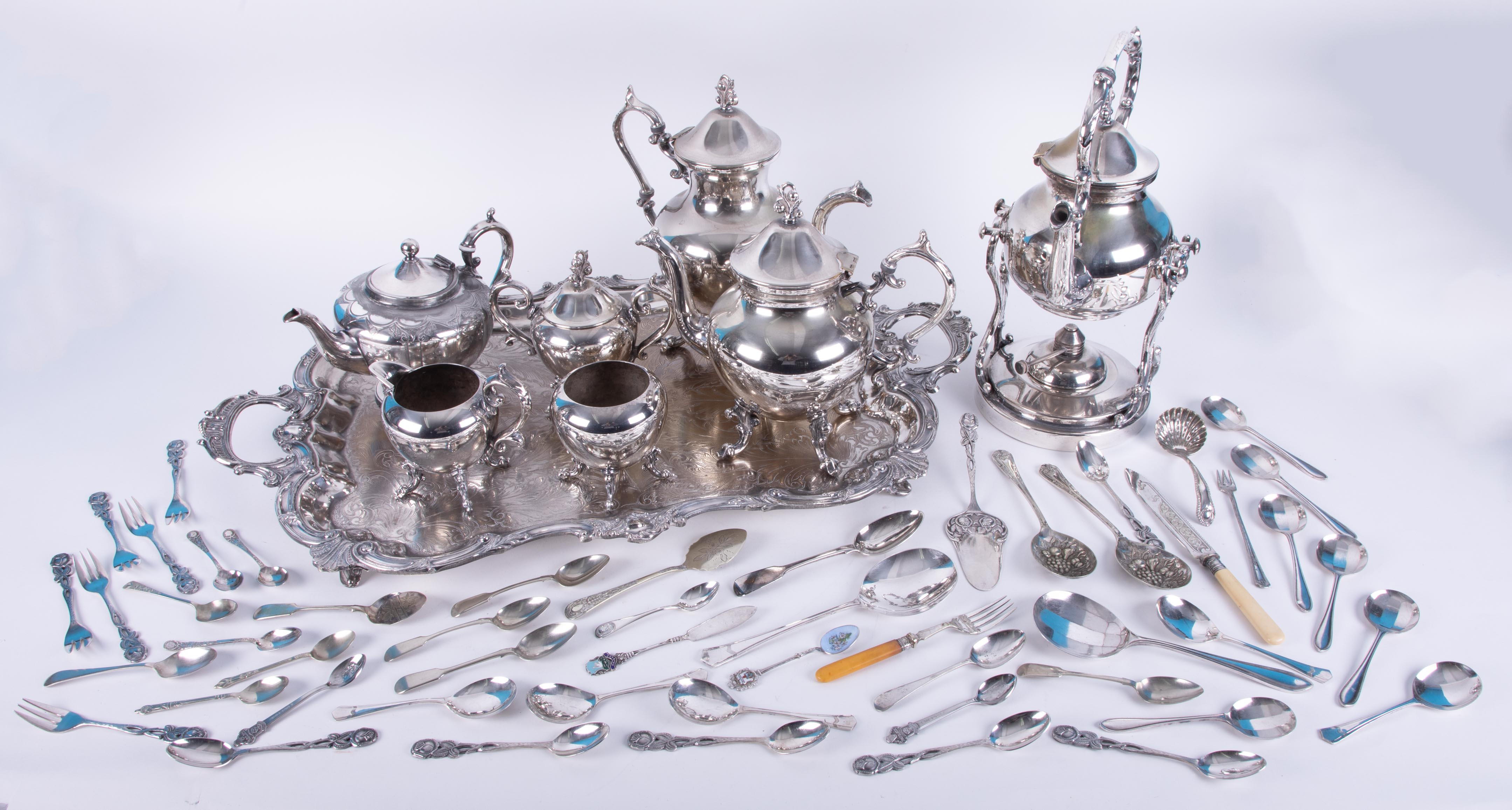 A silver plated tea service with tray including a spirit kettle together with fancy tea spoons,