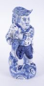 A 19th Century Dutch Delft Hearty Good Fellow Toby jug, the whole decorated in blue and white