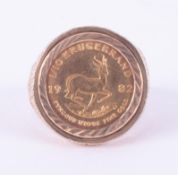 A 9ct yellow gold ornate ring set with a 1/10 Krugerrand 1982, 7.60gm, approx. size M.