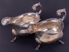 Two similar Georgian silver sauce boats, hallmarked London, each with acanthus scroll handle,