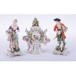 A pair of 19th Century German porcelain figures also a German porcelain ornate small vase and cover