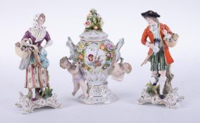 A pair of 19th Century German porcelain figures also a German porcelain ornate small vase and cover