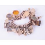 A 9ct rose gold heart padlock charm bracelet with 26 x charms