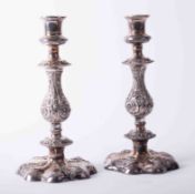 Pair of Georgian style silver plated candlesticks with heavily embossed scroll columns on padded