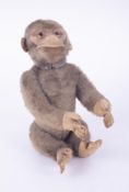 A vintage stuffed mohair? yes/no monkey with a moveable tail that operates the head