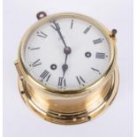 Chutz, a brass cased ships bulk head clock with key, diameter 15cm.