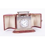 A Victorian silver triangular desk clock by John Manger, London 1896, fitted with a barometer,