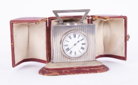 A Victorian silver triangular desk clock by John Manger, London 1896, fitted with a barometer,