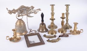 A mixed collection of metal wares including candlesticks, bells etc.
