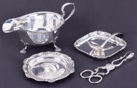 A Mappin & Webb silver sauceboat, small ladle, pin dish with embossed Art Nouveau decoration and
