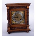 A Victorian carved walnut mantle clock, eight day movement, with key, 35cm.