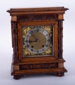 A Victorian carved walnut mantle clock, eight day movement, with key, 35cm.