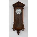 A mahogany cased Vienna style wall clock with two train movement, with pendulum and weights.