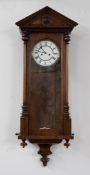 A mahogany cased Vienna style wall clock with two train movement, with pendulum and weights.