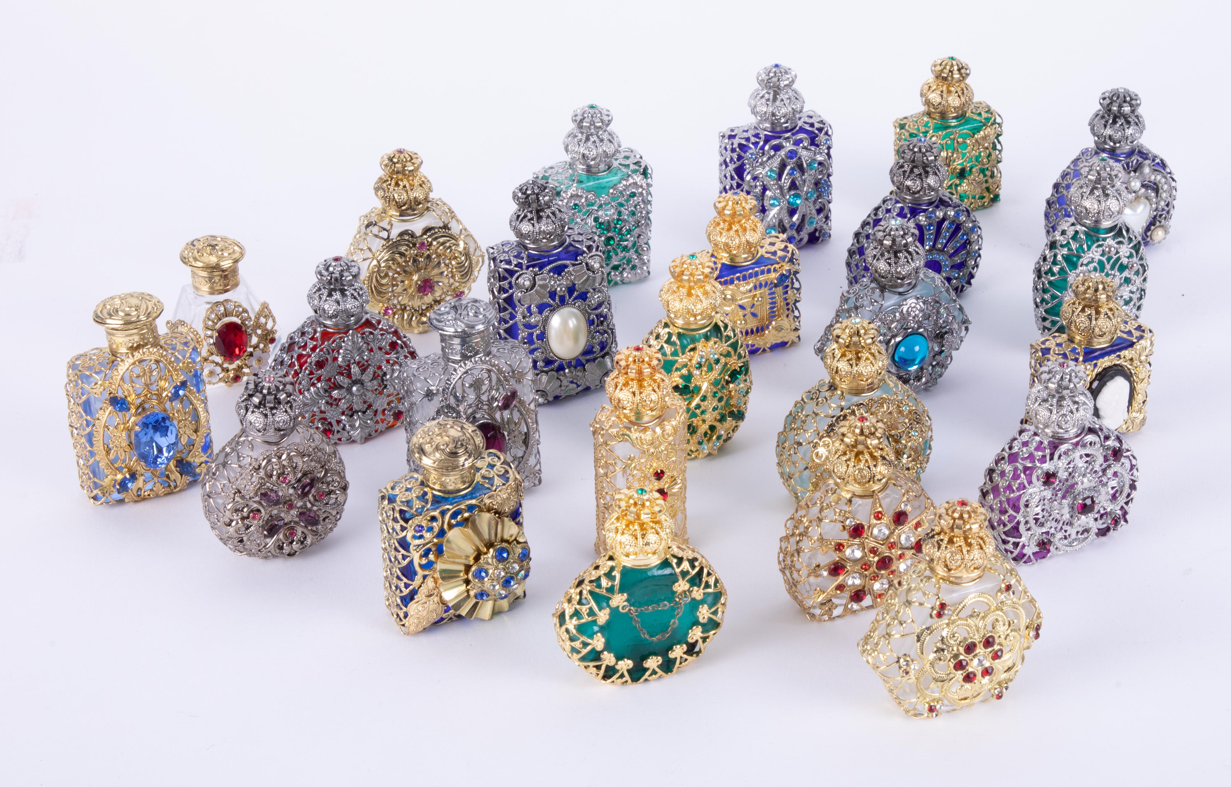 A collection of twenty four decorative modern perfume bottles together with a modern gilt