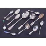 An assortment of ten silver spoons including caddy spoon, pierced silver sifter, jam spoon,