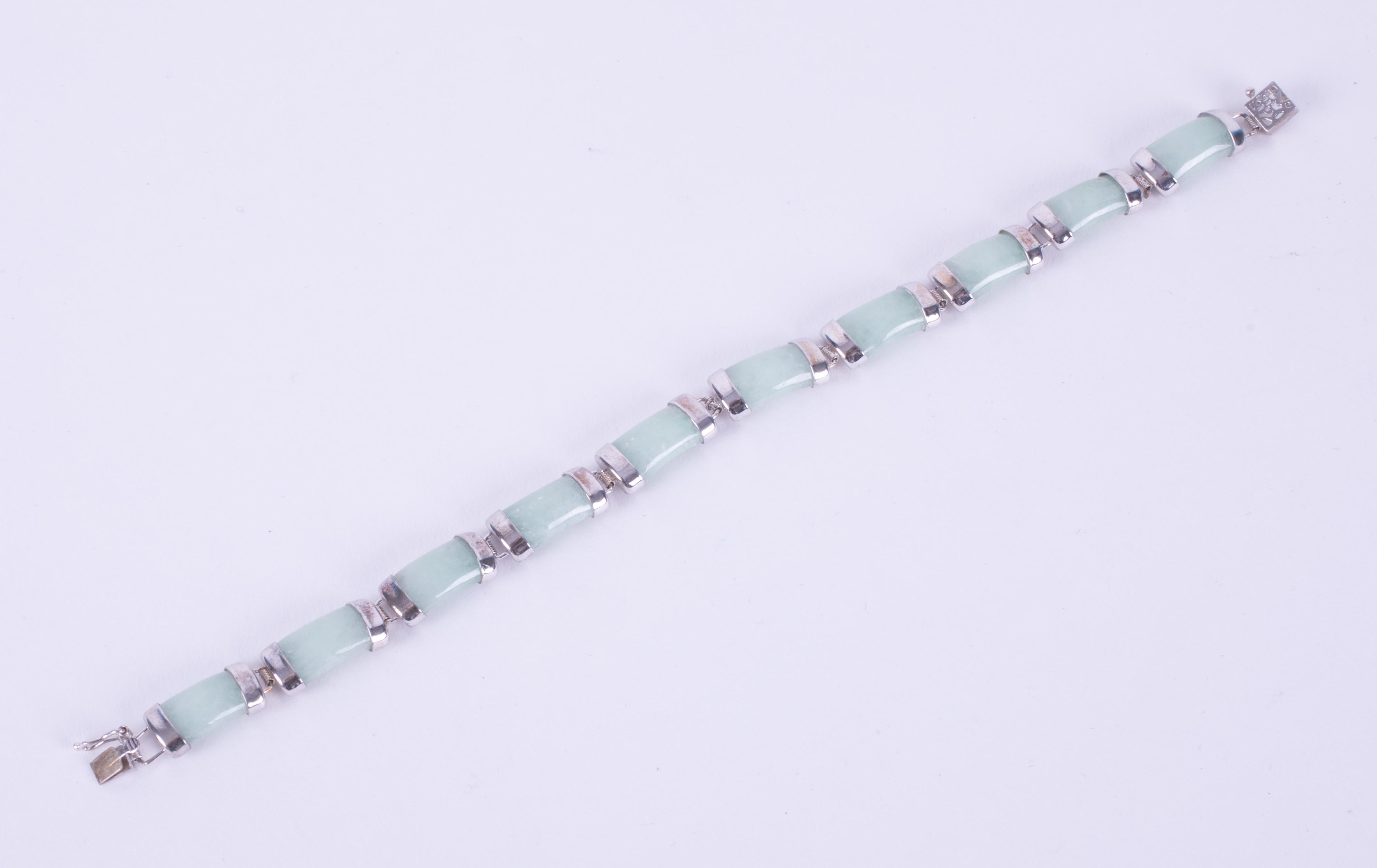 A silver bracelet set with 20 carats of genuine Jade, from Gemporia and comes with a