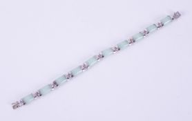 A silver bracelet set with 20 carats of genuine Jade, from Gemporia and comes with a