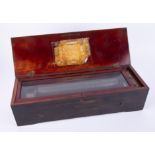 A 19th Century music box in a faux rosewood case, fitted with a 13 inch cylinder, the comb lacks two