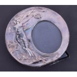 Silver circular photo frame with Art Nouveau embossed decoration, diameter 16.5cm.