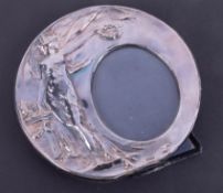 Silver circular photo frame with Art Nouveau embossed decoration, diameter 16.5cm.