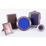 Five assorted silver photo frames, including circular model, 14cm diameter.