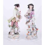 A pair of 19th Century Vienna porcelain figures one depicting a bagpipe player in period costume