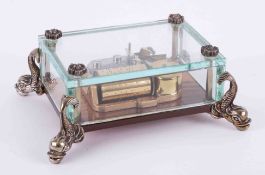 Reuge Music, Swiss table music box in glass case with dolphin supports.