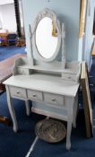 A modern dressing table of traditional style with mirror and an arrangement of drawers in grey,