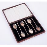 A set of six George V silver seal top tea spoons, cased.