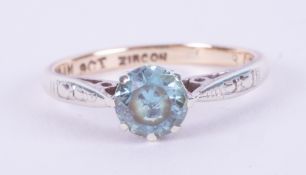 A 9ct yellow & white gold ring set with a round cut blue zircon, 1.76gm, size J.