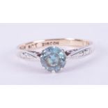 A 9ct yellow & white gold ring set with a round cut blue zircon, 1.76gm, size J.