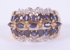 A 9ct yellow gold ring set with marquise & round cut dark blue sapphires interspaced with small