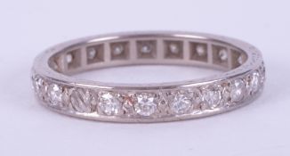 A platinum? (not hallmarked or tested) full eternity ring set with round brilliant cut diamonds,