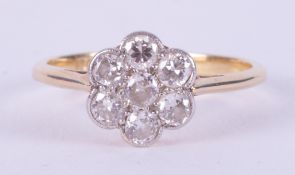 An 18ct yellow gold & platinum daisy ring set with old round cut diamonds, 2.20gm, size L 1/2 to M.