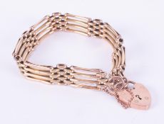 A 9ct rose & yellow gold fancy link gate bracelet with heart padlock and safety chain, 14.85gm.