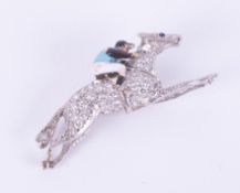 An antique platinum? (not hallmarked or tested) brooch of a jockey on a horse, the jockey is