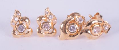 Two pairs of yellow gold? ornately designed stud earrings with round cut white stones (not testing